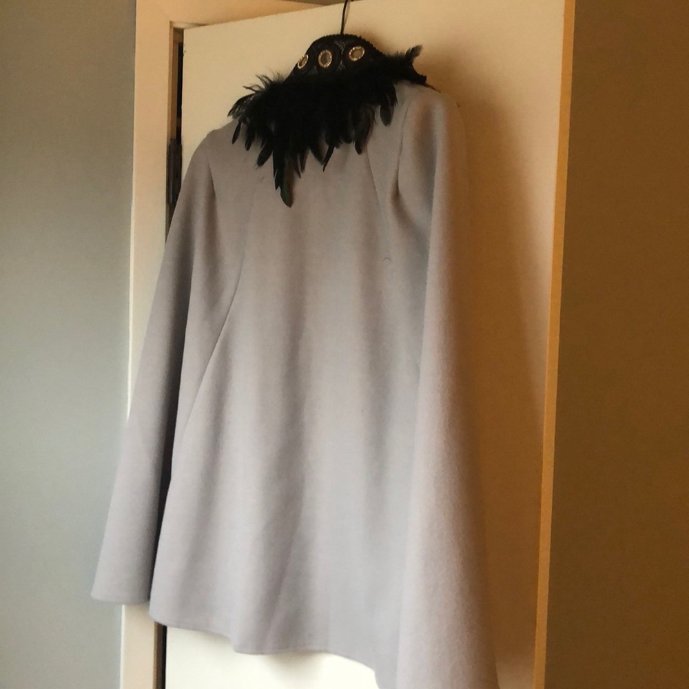 She in coat with black feathers
